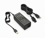 A black Lenovo laptop power adapter with a yellow square USB tip and two-pronged plug, alongside a power cord.